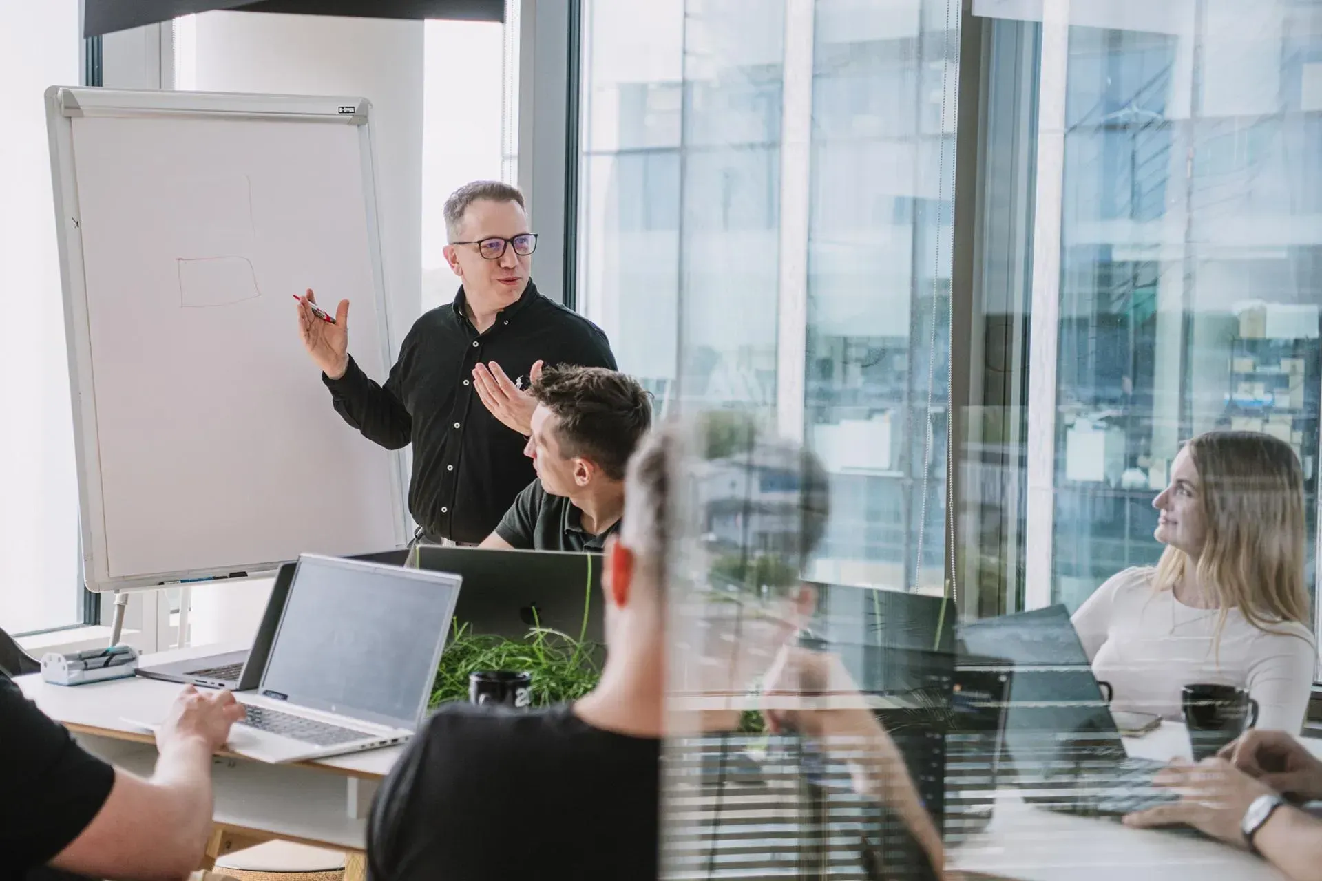 Our developer presents to a group of people in an office.
